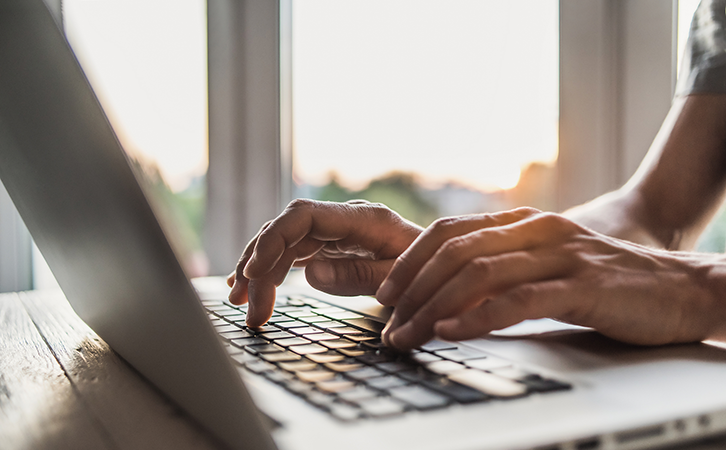 A man sitting at a laptop